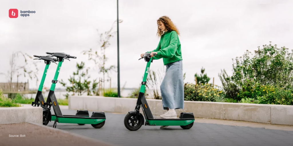 Woman riding a Bolt electric scooter outdoors, illustrating shared mobility in practice